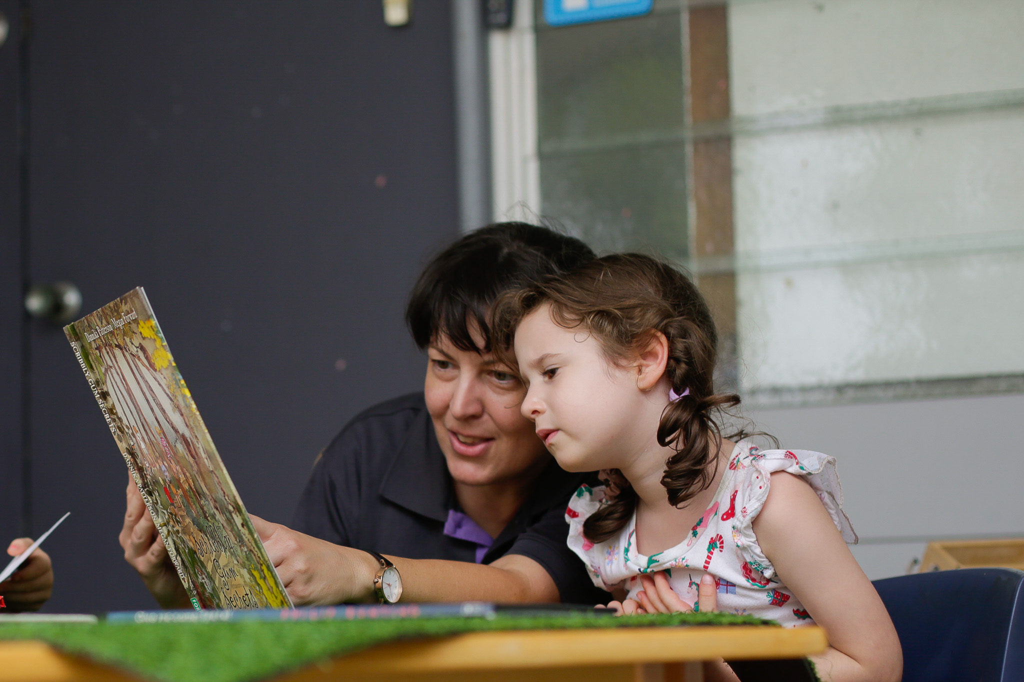 Her transferrable skills help Belinda in her role today (pictured with a child at her centre)